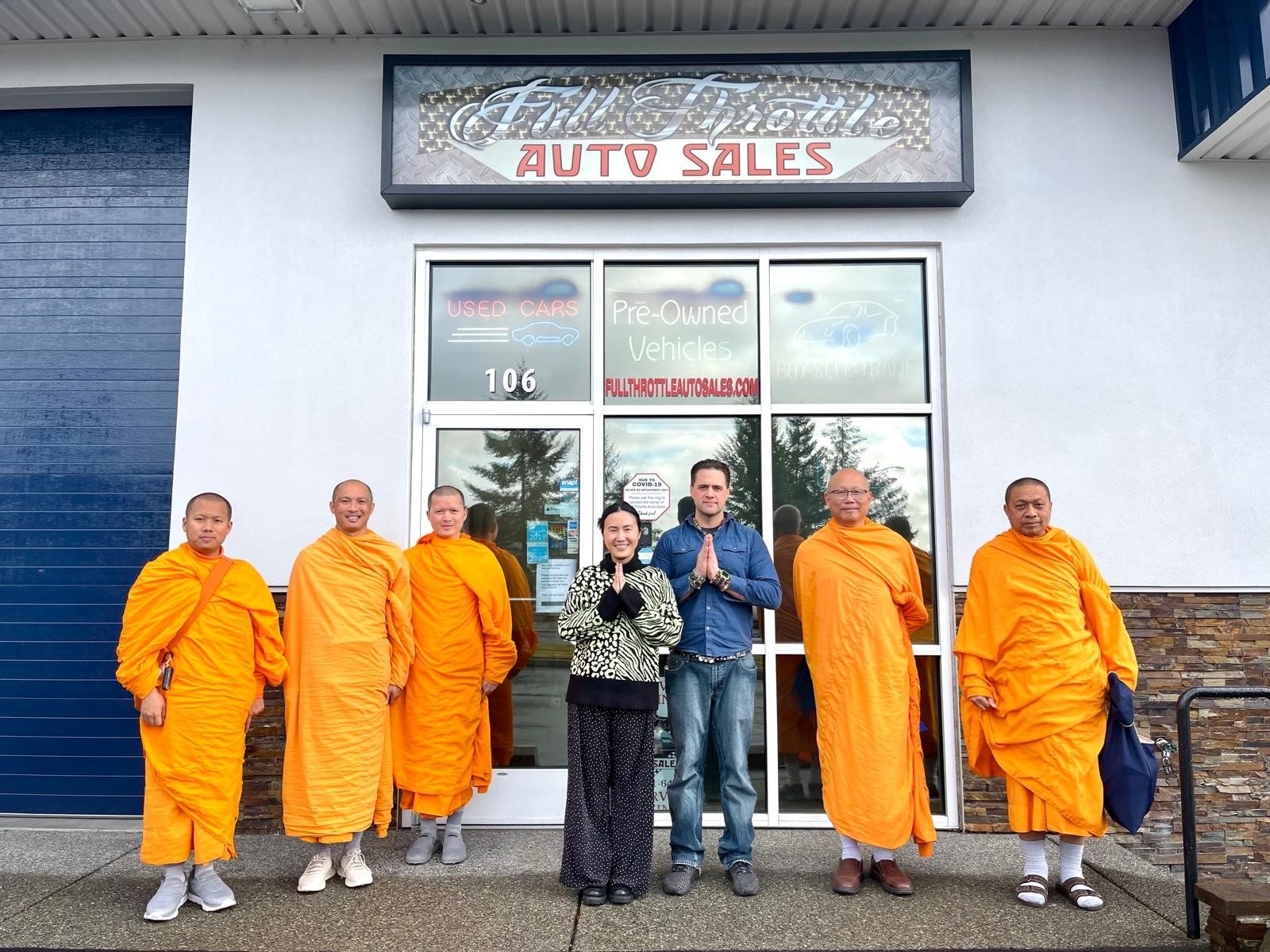 Buddhist monks visiting Full Throttle Auto Sales in Tacoma, WA