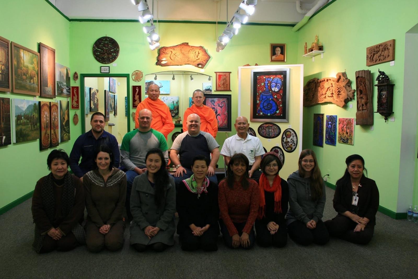 A meditation group seated together in a gallery room