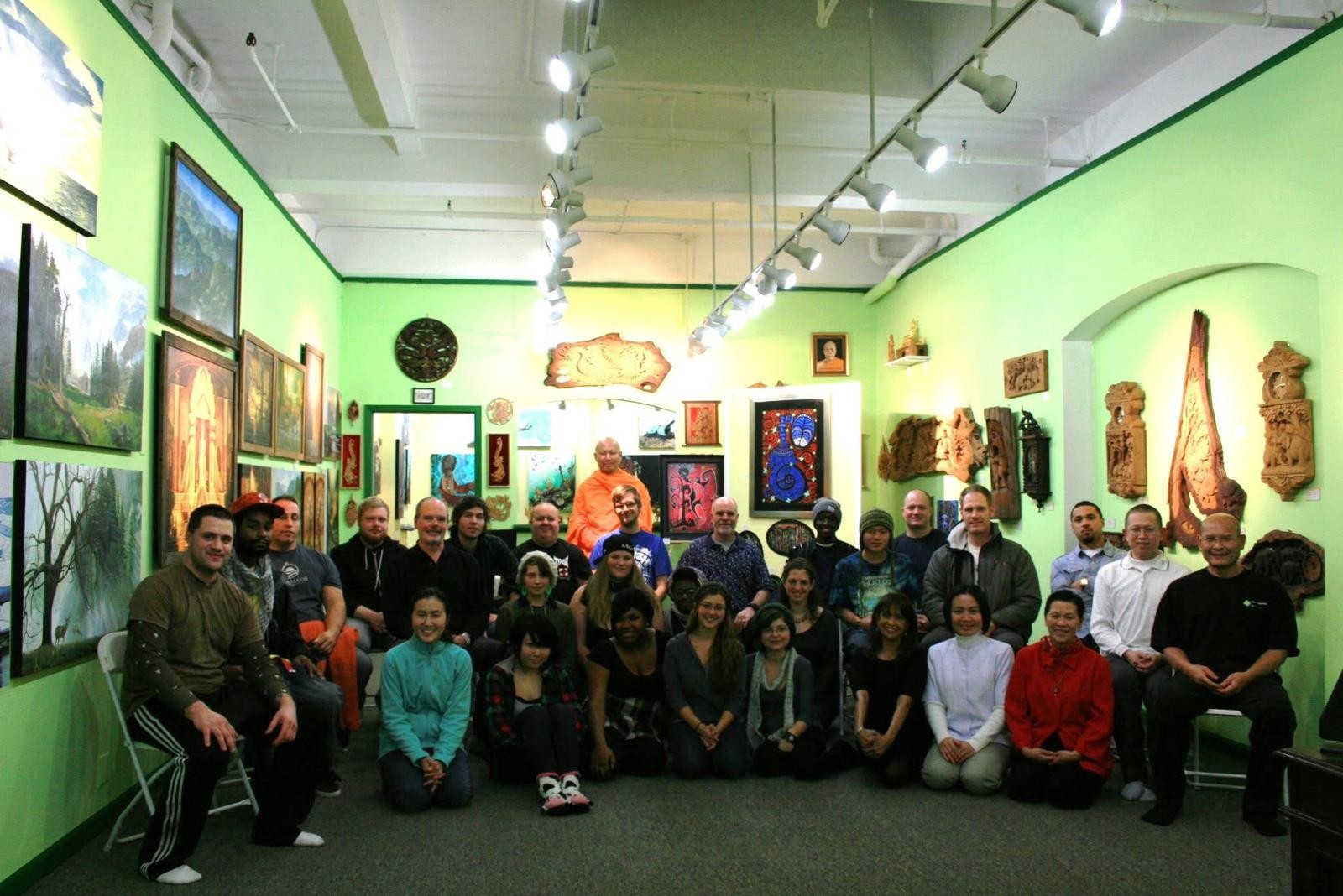 A meditation group gathered in a gallery room with monks